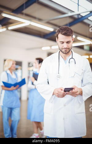 Male doctor using mobile phone Stock Photo