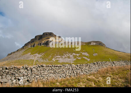 pen-y-gent mountain in winter in yorkshire dales with dry stone wall & limestone pavement on 3 peaks walking trail Stock Photo