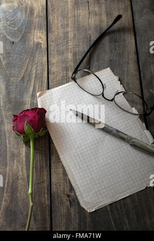 Love letter and rose on wooden background, from above Stock Photo