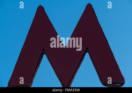 Letter M - the symbol of the Moscow Metro on blue sky background Stock Photo