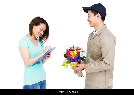 Delivery man delivering flowers to woman Stock Photo