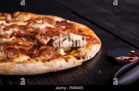 Mighty Meaty Pizza on a thin and crisp pizza crust. Stock Photo