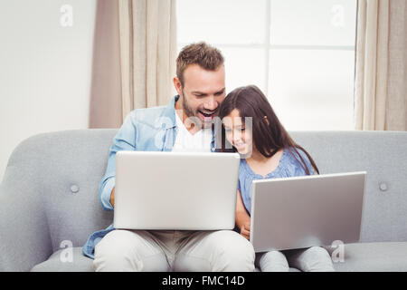 Father and daughter using laptop Stock Photo