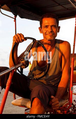 Cuba, Guantanamo, Baracoa, Smiling man driving an old tractor Stock Photo