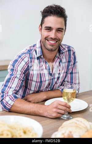 Handsome young man drinking wine at table Stock Photo