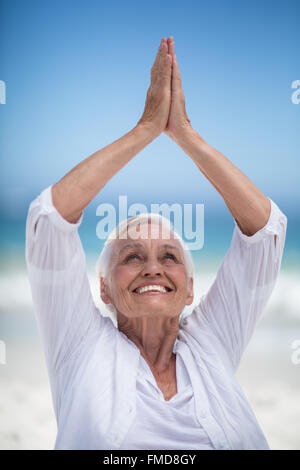 Beautiful mature woman posing with hands joined Stock Photo