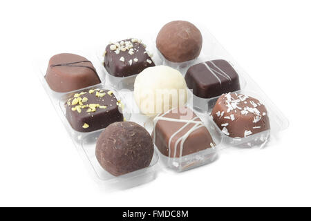 assorted chocolate bites in a small plastic box with individual rooms Stock Photo
