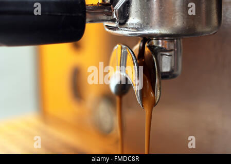 espresso shot from coffee machine in coffee shop vintage color Stock Photo
