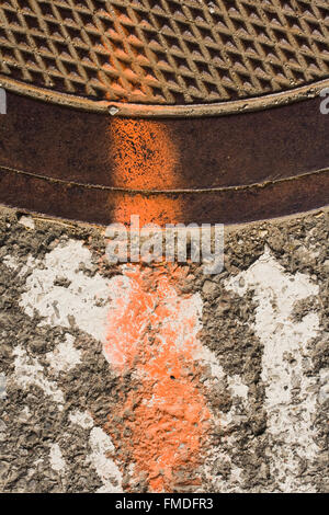 Manhole cover with grungy texture and paint Stock Photo