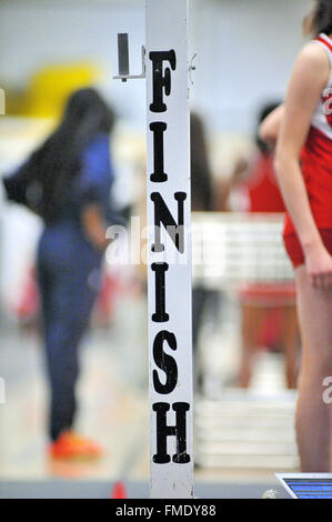 The goal of all runners during track events looms at the end of the race at an indoor high school meet. USA. Stock Photo