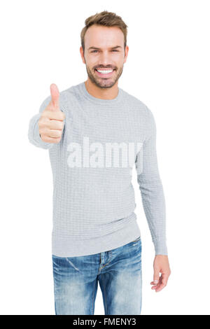 Young man smiling and giving a thumbs up Stock Photo