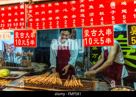 Market vendors at Wangfujing snack street offer their customers a very wide variety of foods Stock Photo