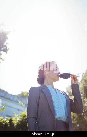 Pretty businesswoman enjoying a glass of wine Stock Photo