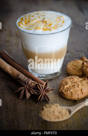 a glass of hot latte art coffee on wooden table Stock Photo