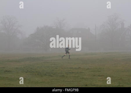 Wimbledon, London, UK. 12th Mar, 2016. Peoplle walk on Wimbledon Common covered in early morning fog Credit:  amer ghazzal/Alamy Live News Stock Photo