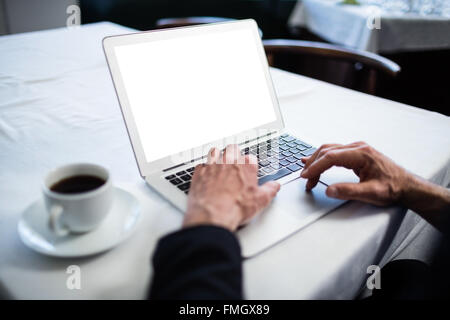 Businessman using his laptop at restaurant Stock Photo