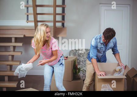Couple unpacking boxes in new house Stock Photo