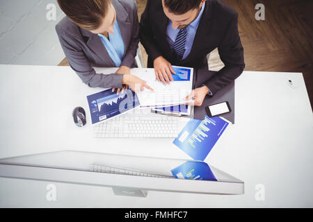 Business people discussing over documents Stock Photo