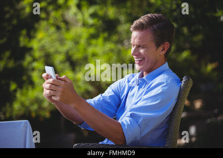 Handsome businessman texting Stock Photo