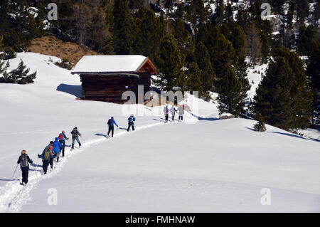 Group of People Snow Shoeing in the Italian Dolomites Stock Photo