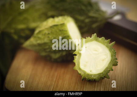 Sliced Green Momordica or karela on chopping board Stock Photo