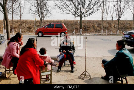 Yuncheng, China's Shanxi Province. 12th Mar, 2016. Patients having infusion treatment move outdoor due to a 4.4-magnitude earthquake in Longju Township of Yanhu District, Yuncheng City, north China's Shanxi Province, March 12, 2016. An earthquake measured 4.4 magnitude on the Richter scale jolted the Yanhu District of Yuncheng City at 11:14 a.m. (0314 GMT) Saturday. © Bao Dongsheng/Xinhua/Alamy Live News Stock Photo