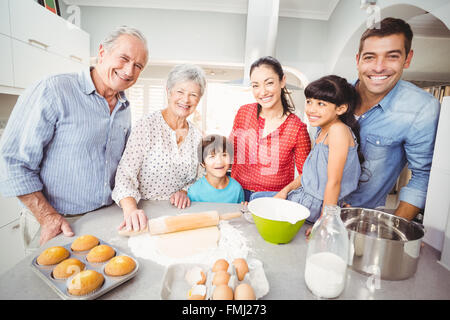 Portrait of happy family making bread in kitchen Stock Photo