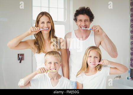 Portrait of smiling family brushing teeth Stock Photo
