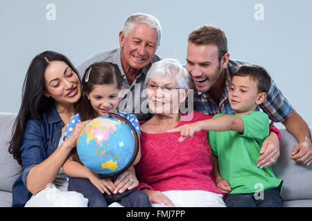 Happy family sitting on sofa Stock Photo