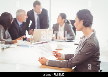 Businesswoman reading a report Stock Photo