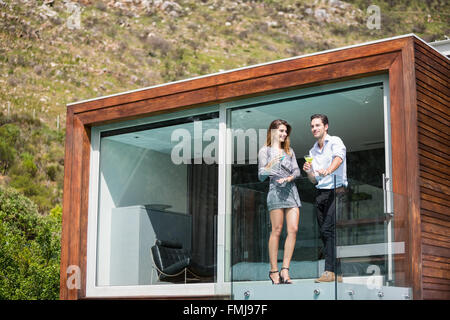 Young couple standing in balcony at resort Stock Photo