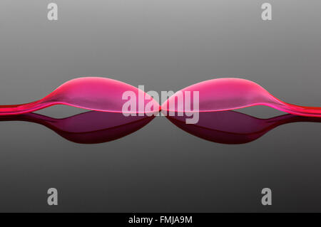 Two pink Plastic Spoons Stock Photo