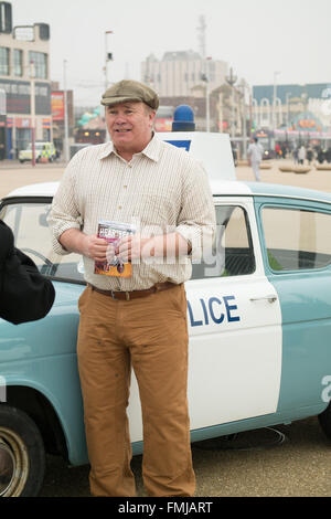 Blackpool,UK, 12th March 2016. Entertainment news. Actor David Lonsdale who plays the 'village fool' David Stockwell in the long running police series 'Heartbeat' promotes the new theatre tour based on the progamme at Blackpool's comedy carpet today. Posing for photograph's with the original police car from the show David speaks to members of the public to highlight this new theatre tour which starts at Blackpool's Grand Theatre on Wednesday the 16th of March. 2016. The nationwide tour finishes at Wolverhampton in July of this year Credit: Gary Telford/Alamy live news Stock Photo