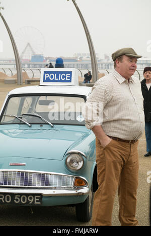 Blackpool,UK, 12th March 2016. Entertainment news. Actor David Lonsdale who plays the 'village fool' David Stockwell in the long running police series 'Heartbeat' promotes the new theatre tour based on the progamme at Blackpool's comedy carpet today. Posing for photograph's with the original police car from the show David speaks to members of the public to highlight this new theatre tour which starts at Blackpool's Grand Theatre on Wednesday the 16th of March. 2016. The nationwide tour finishes at Wolverhampton in July of this year Credit: Gary Telford/Alamy live news Stock Photo