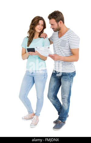 Worried couple calculating bill on calculator