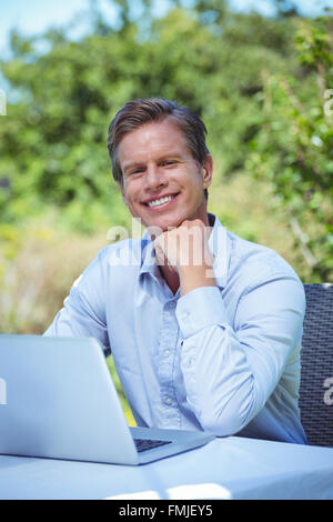 Smiling businessman using laptop Stock Photo