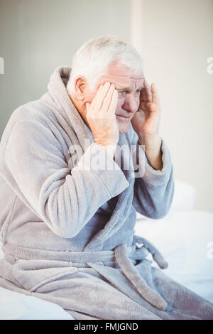 Man Sitting On Bed Suffering From Back Pain Stock Photo - Alamy