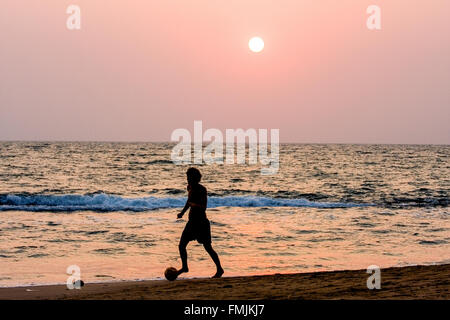 Playing football on Anjuna Beach at sunset. ,hippy,hippie,Goa,India,Asia, Stock Photo