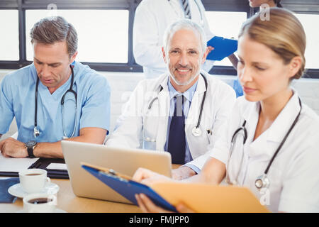 Male doctor using laptop in conference room Stock Photo