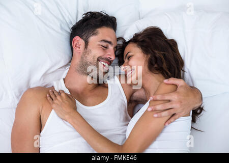 High angle view of happy couple relaxing on bed Stock Photo