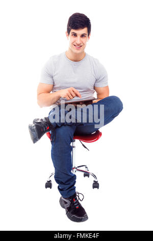 Smiling handsome latin man using a tablet computer, isolated over a white background Stock Photo