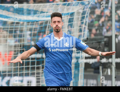 Darmstadt, Germany. 12th Mar, 2016. Darmstadt's fans holding up a photo ...