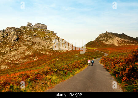 Walkers on the SW Coast Path where the bracken has turned an autumnal brown in the Valley of Rocks nr Lynton, Devon, England, UK Stock Photo