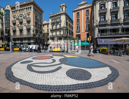Pla de l'Os mosaic by Joan Miro at La Rambla street in Barcelona, Spain. House of Umbrellas (Casa Bruno Cuadros) on left side Stock Photo