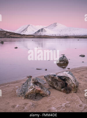 Lochan na h-Achlaise on Rannoch Moor, just before sunrise looking towards the snow covered Black Mount range. One of the classic Stock Photo