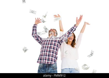 Happy young couple throwing currency notes in air Stock Photo