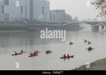Canoeists on Thames. People enjoyed a bright but misty day on and around the Thames in London. Canoeists Stock Photo