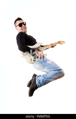casual man playing an electric guitar and jumping Stock Photo
