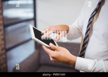 Midsection of businessman using digital tablet Stock Photo