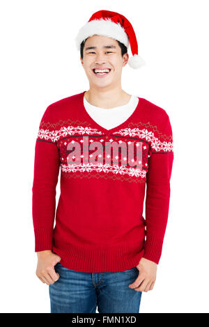 Young man wearing santa hat looking at camera and smiling Stock Photo